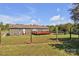 Home's rear exterior with a large yard, deck, and plenty of privacy surrounded by lush trees at 725 Hunters Ridge Rd, Taylorsville, NC 28681
