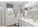Bright bathroom with double vanity sinks, framed mirrors, and glass shower at 7631 Griffins Gate Sw Dr, Concord, NC 28025