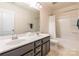 Bright bathroom featuring double sinks with modern fixtures and a shower-tub combination at 7711 Kelburn Ln, Charlotte, NC 28273