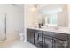 Bathroom featuring double vanity sinks with modern fixtures and stylish cabinetry at 7711 Kelburn Ln, Charlotte, NC 28273