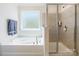 Bathroom featuring soaking tub, separate shower, and large window at 7711 Kelburn Ln, Charlotte, NC 28273