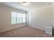 Cozy bedroom featuring neutral walls, large window, and plush carpeting at 7711 Kelburn Ln, Charlotte, NC 28273