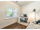 Bedroom or office with hardwood floors, a large window, and a desk setup at 7711 Kelburn Ln, Charlotte, NC 28273