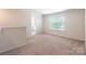 Bright bedroom featuring neutral walls, large windows, and plush carpeting at 7711 Kelburn Ln, Charlotte, NC 28273