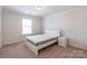 Cozy bedroom featuring neutral walls, large window, and plush carpeting at 7711 Kelburn Ln, Charlotte, NC 28273