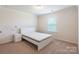 Cozy bedroom featuring neutral walls, large window, and plush carpeting at 7711 Kelburn Ln, Charlotte, NC 28273