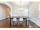 Dining room featuring hardwood floors, wainscoting and a modern chandelier at 7711 Kelburn Ln, Charlotte, NC 28273