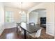 Dining room featuring hardwood floors, wainscoting and a modern chandelier at 7711 Kelburn Ln, Charlotte, NC 28273