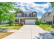 Two story home with neutral siding, brick accents, landscaping and two car garage at 7711 Kelburn Ln, Charlotte, NC 28273