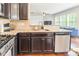 Kitchen with granite countertops, stainless steel appliances, hardwood floors and dark wooden cabinets at 7711 Kelburn Ln, Charlotte, NC 28273