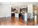 Open kitchen featuring granite countertops, stainless steel appliances, an island, and dark wood cabinets at 7711 Kelburn Ln, Charlotte, NC 28273