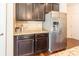 Kitchen with stainless steel refrigerator, dark cabinets, granite countertops and hardwood floors at 7711 Kelburn Ln, Charlotte, NC 28273