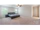 Spacious main bedroom with a ceiling fan, large bed, and two windows offering natural light at 7711 Kelburn Ln, Charlotte, NC 28273