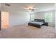 Spacious main bedroom with ceiling fan, and plush carpeting at 7711 Kelburn Ln, Charlotte, NC 28273