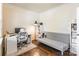 Home office with hardwood floors, futon, desk, floor lamp, and a bookcase at 7711 Kelburn Ln, Charlotte, NC 28273