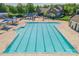 Community pool with lounge chairs, sun shades and clubhouse at 7711 Kelburn Ln, Charlotte, NC 28273