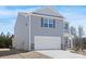 Charming two-story home with gray siding, stone accents and a two car garage at 822 N Naughton St, Chester, SC 29706