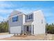 Charming two-story home with gray siding, stone accents and a two car garage at 822 N Naughton St, Chester, SC 29706
