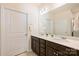 Bathroom with double sink vanity and dark wood cabinetry and decorative mirror at 8853 Brakeman Dr, Waxhaw, NC 28173