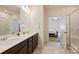 Bathroom featuring double sink vanity, tile floors, and a glass-enclosed shower at 8853 Brakeman Dr, Waxhaw, NC 28173