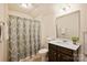 Bathroom featuring a vanity with dark wood cabinets, shower with a decorative curtain and tile floor at 8853 Brakeman Dr, Waxhaw, NC 28173