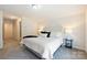 Bright bedroom featuring neutral walls, plush carpeting, and a comfortable bed with stylish bedside table at 8853 Brakeman Dr, Waxhaw, NC 28173