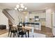 Dining area leading into a kitchen with an island and seating, perfect for entertaining and casual meals at 8853 Brakeman Dr, Waxhaw, NC 28173