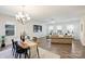 Dining area with wooden table, modern chairs, and lots of natural light, adjacent to the living area at 8853 Brakeman Dr, Waxhaw, NC 28173