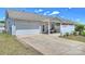 Exterior view featuring a well-maintained driveway, an attached garage, and a covered patio at 8853 Brakeman Dr, Waxhaw, NC 28173