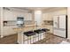 Modern kitchen features granite countertops, stainless steel appliances, and a kitchen island with bar seating at 8853 Brakeman Dr, Waxhaw, NC 28173