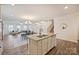 Bright kitchen features an island with a sink, dining area, and a clear view of the staircase at 8853 Brakeman Dr, Waxhaw, NC 28173