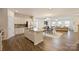 Open concept kitchen with an island, granite countertops, and views of the dining and living spaces at 8853 Brakeman Dr, Waxhaw, NC 28173