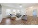Bright living room with hardwood floors, large windows, and modern furniture for comfortable living and natural light at 8853 Brakeman Dr, Waxhaw, NC 28173