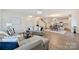 Open floor plan showcasing living room with modern furniture flowing into the dining area and kitchen at 8853 Brakeman Dr, Waxhaw, NC 28173