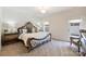 Elegant bedroom with large decorative bedframe, neutral color palette, and cozy carpet flooring at 8853 Brakeman Dr, Waxhaw, NC 28173