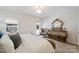 A comfortable bedroom with a large bed, dresser, and a door leading to an outdoor space at 8853 Brakeman Dr, Waxhaw, NC 28173