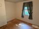 Empty bedroom featuring laminate floors, one window, and decorative curtains at 910 Absher Rd, Statesville, NC 28625