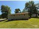 Back view of house showing green lawn and trees at 910 Absher Rd, Statesville, NC 28625