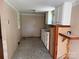 A compact kitchen with white cabinets, basic appliances, and tiled flooring at 910 Absher Rd, Statesville, NC 28625
