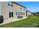 This backyard features a patio with outdoor seating, lush grass, and nice landscaping at 9301 Swimming Dr, Harrisburg, NC 28075