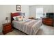 Bedroom featuring stylish bed, bedside tables, dresser with television, and window at 9301 Swimming Dr, Harrisburg, NC 28075