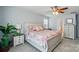 Bright bedroom with a ceiling fan, queen bed, and white curtains at 9301 Swimming Dr, Harrisburg, NC 28075