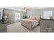Bright bedroom with a ceiling fan, queen bed, and white curtains at 9301 Swimming Dr, Harrisburg, NC 28075