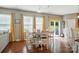 Dining room features hardwood floors, natural light, and a dining table set for six with backyard access at 9301 Swimming Dr, Harrisburg, NC 28075