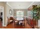 Elegant dining room features hardwood floors, a classic china cabinet, and a chandelier, perfect for entertaining at 9301 Swimming Dr, Harrisburg, NC 28075
