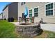 This backyard features a stone fire pit that complements the outdoor seating and grass at 9301 Swimming Dr, Harrisburg, NC 28075