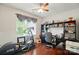 Well-lit home office with hardwood floors, a large window, and ample storage space provides a productive work environment at 9301 Swimming Dr, Harrisburg, NC 28075