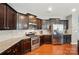 Well-equipped kitchen with stainless steel appliances, granite countertops, and stylish dark cabinetry at 9301 Swimming Dr, Harrisburg, NC 28075