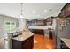 Bright and open kitchen with granite countertops, stainless appliances, and an eat-in dining space at 9301 Swimming Dr, Harrisburg, NC 28075