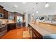 Open kitchen featuring granite countertops, stainless steel appliances, and an adjacent living area at 9301 Swimming Dr, Harrisburg, NC 28075